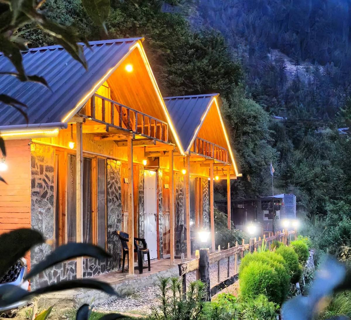 Mudhouse cottages lit up at dusk